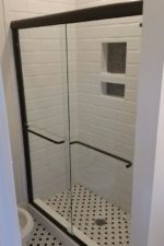 Black and White Shower with glass door by Bryn Mawr Glass